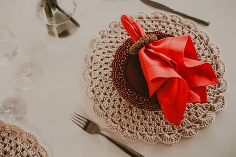 From above arrangement of fancy banquet set with red napkin in holder on brown ceramic plate